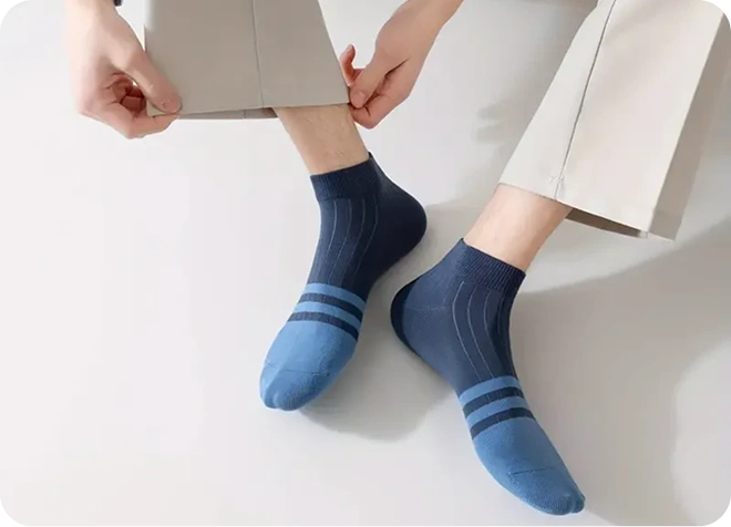 Person wearing blue socks with a white background